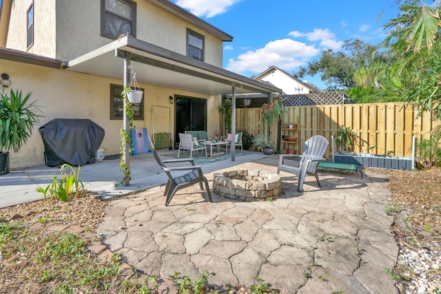 view of patio / terrace with grilling area and a fire pit