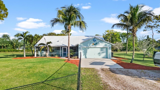 view of front of house featuring a front yard and a garage