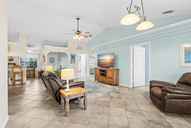 tiled living room with ceiling fan and vaulted ceiling