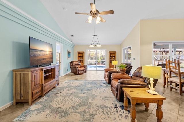 living room featuring ceiling fan, light tile patterned floors, and lofted ceiling