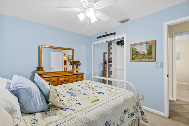 carpeted bedroom with ceiling fan and a closet