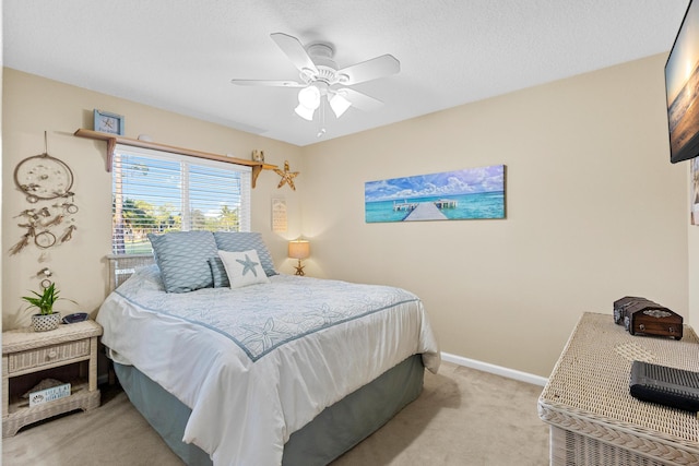 bedroom featuring ceiling fan and light carpet