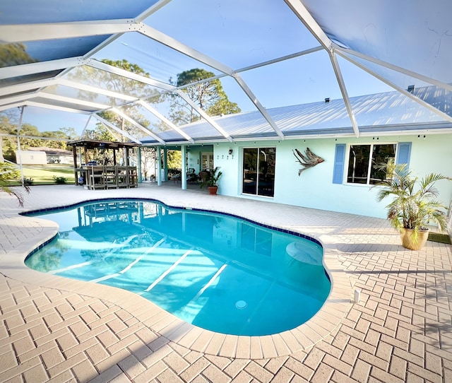 view of pool with a patio and a lanai