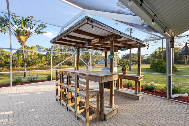 view of home's community with a lawn, an outdoor bar, and a patio