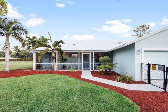 single story home with a front yard and a garage