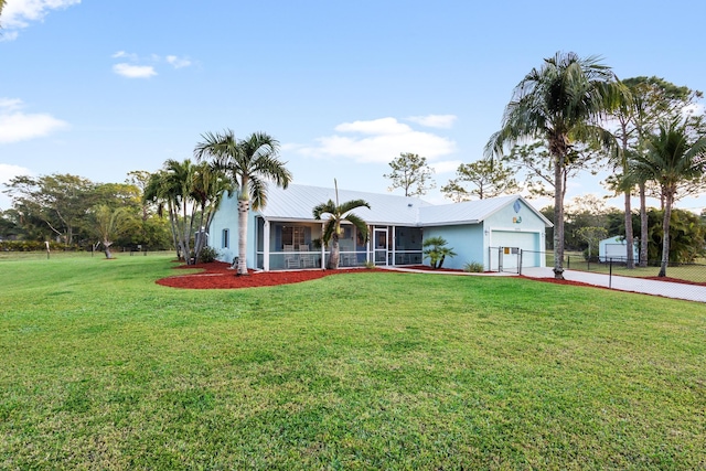 view of front of house with a front yard and a garage