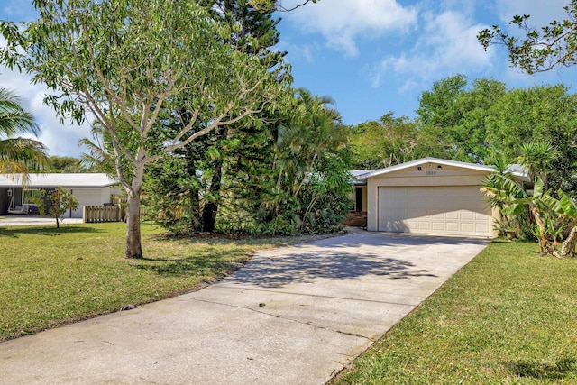 view of front of house featuring concrete driveway, a front yard, and stucco siding