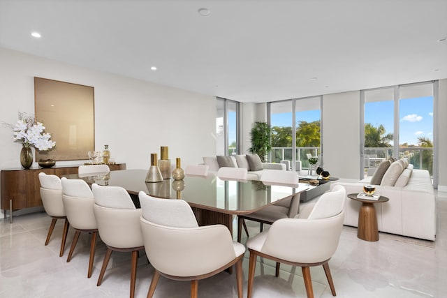 dining room featuring a wall of windows and a healthy amount of sunlight