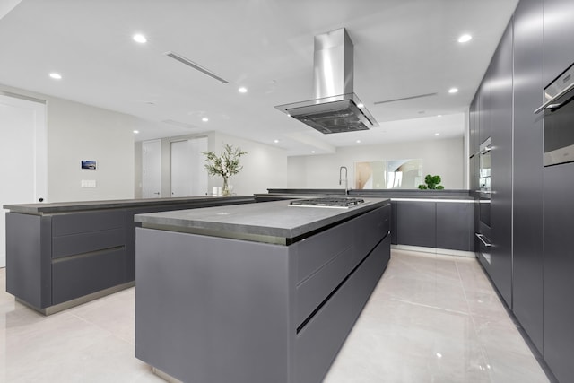 kitchen featuring a spacious island, kitchen peninsula, stainless steel gas stovetop, and island exhaust hood