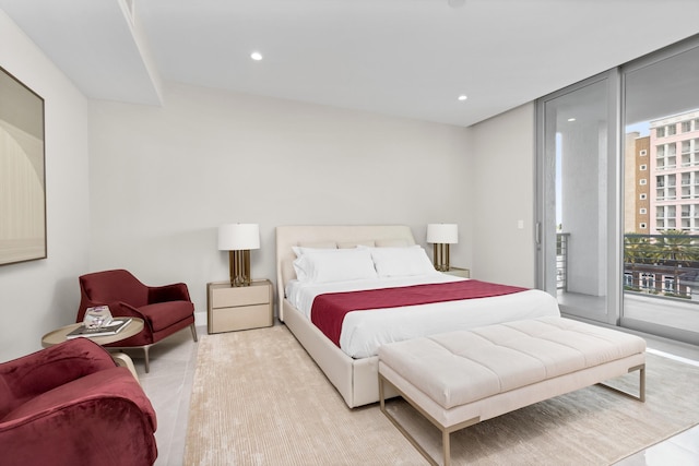 tiled bedroom featuring access to exterior and floor to ceiling windows