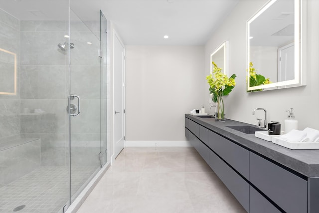 bathroom featuring a shower with shower door, tile patterned floors, and vanity