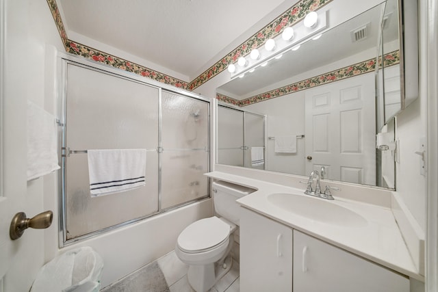 full bathroom featuring tile patterned floors, vanity, toilet, and bath / shower combo with glass door