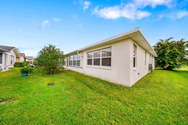 view of property exterior with a lawn