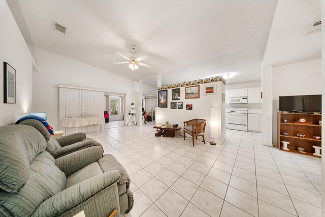 carpeted entryway with ceiling fan and a textured ceiling