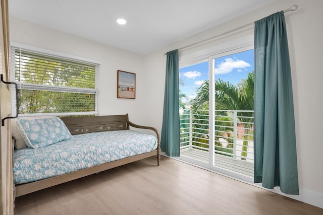 bedroom featuring hardwood / wood-style floors and access to outside