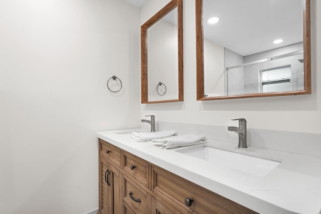 bathroom with vanity and a shower with shower door