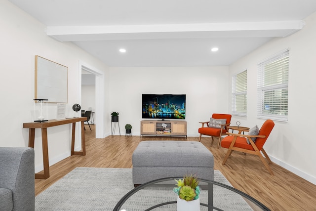 living room featuring light hardwood / wood-style floors and beam ceiling