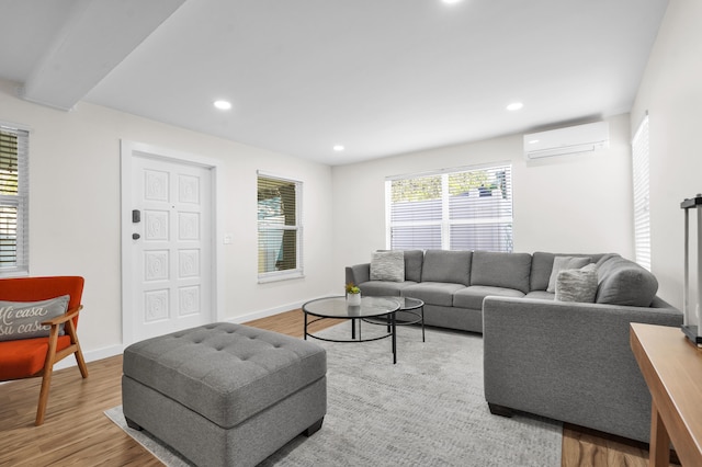 living room with light hardwood / wood-style flooring and a wall mounted AC