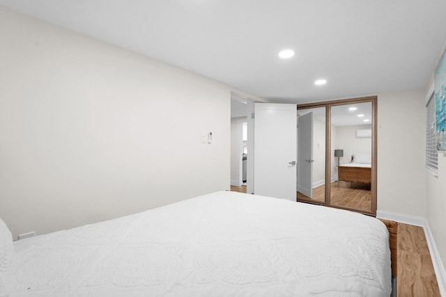 bedroom with hardwood / wood-style flooring and a closet