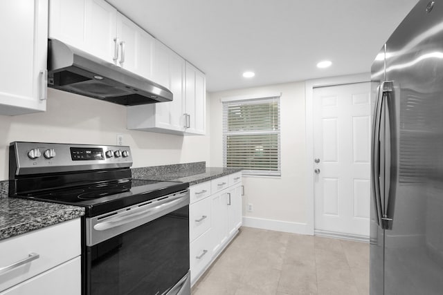 kitchen featuring dark stone countertops, white cabinetry, and stainless steel appliances