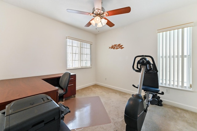 carpeted home office with ceiling fan