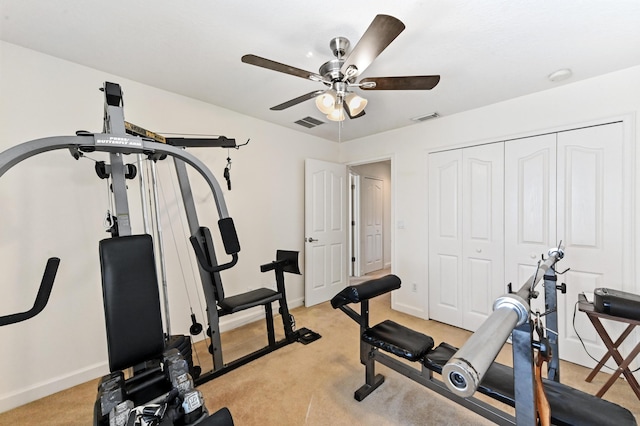 exercise area with ceiling fan and light carpet