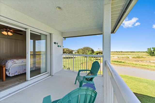 view of patio / terrace featuring a balcony and a rural view