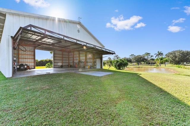 view of yard featuring a water view and an outdoor structure