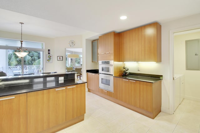 kitchen with washer and dryer, electric panel, hanging light fixtures, and double oven