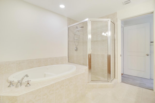 bathroom featuring tile patterned floors and independent shower and bath