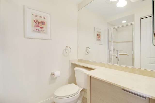 bathroom featuring vanity, toilet, and walk in shower