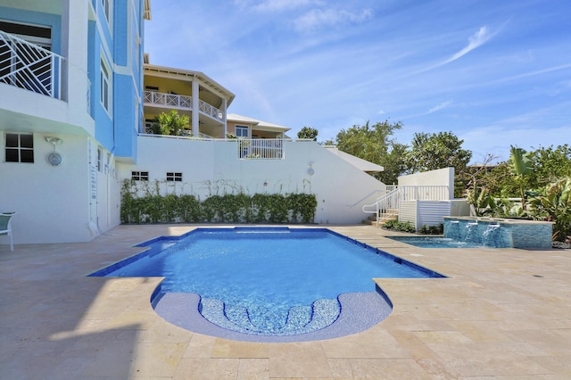 view of pool featuring pool water feature, a jacuzzi, and a patio