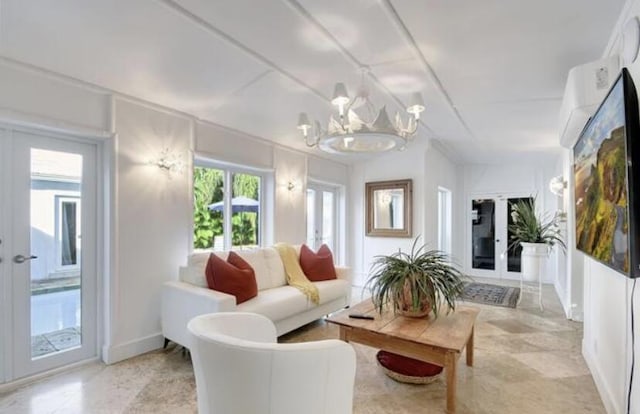 living room with french doors, plenty of natural light, and a notable chandelier