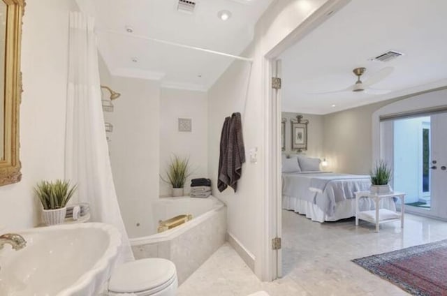 bathroom with a relaxing tiled tub, ceiling fan, toilet, and ornamental molding