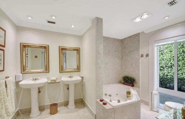 bathroom with tile patterned floors, tiled tub, and ornamental molding