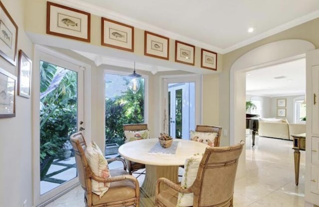 dining space featuring crown molding