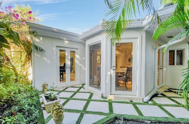 entrance to property featuring french doors and a patio