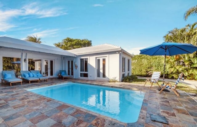 view of pool featuring a patio area and french doors