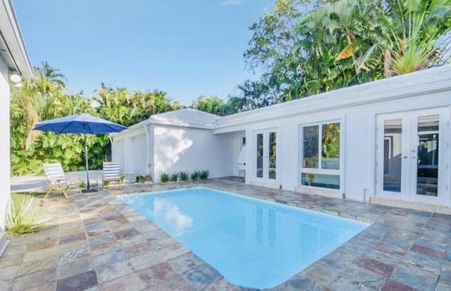 view of pool featuring french doors and a patio area