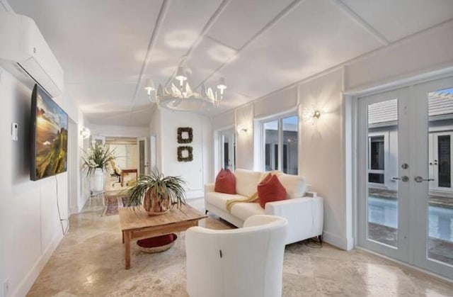 living room featuring a chandelier and french doors