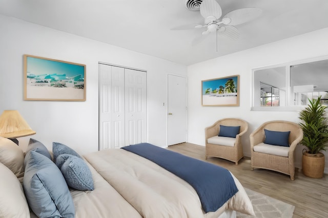 bedroom featuring hardwood / wood-style flooring, ceiling fan, and a closet