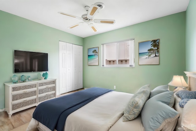 bedroom featuring ceiling fan, a closet, and light hardwood / wood-style floors