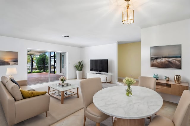 tiled living room featuring a notable chandelier