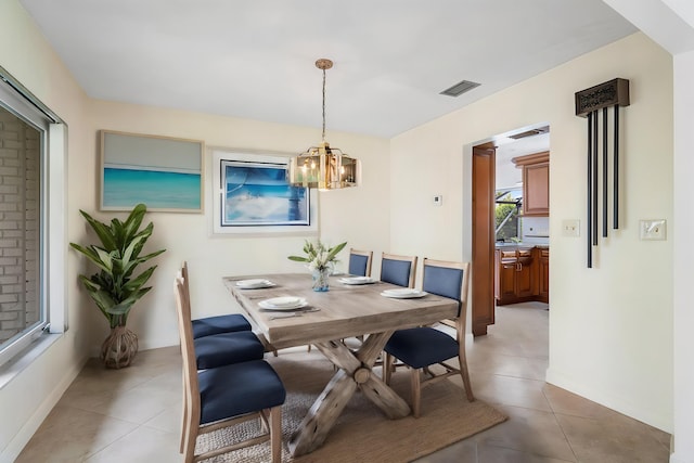 tiled dining space with a notable chandelier