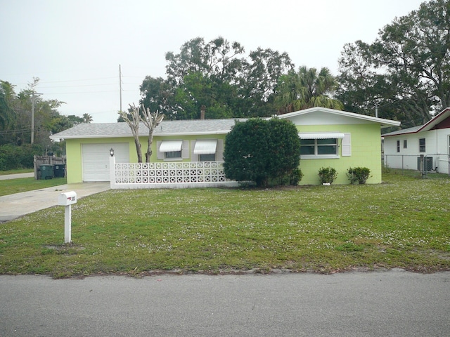 single story home with central AC unit, a garage, and a front lawn