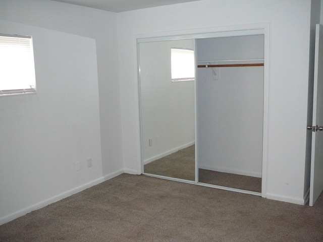 unfurnished bedroom with carpet floors and a closet