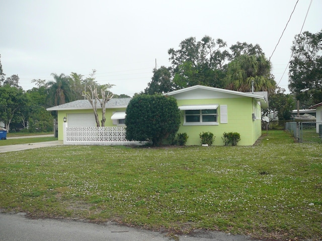 view of home's exterior featuring a lawn and a garage