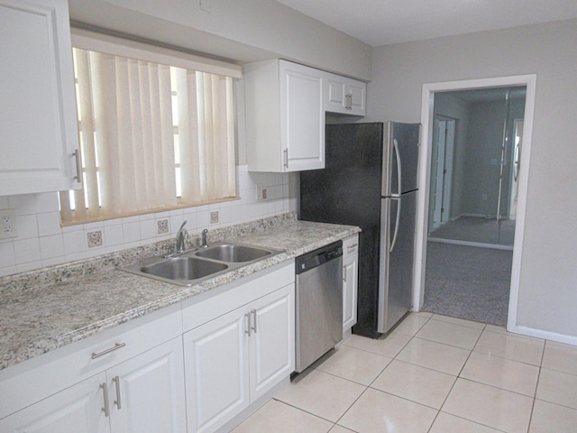 kitchen featuring dishwasher, white cabinetry, and sink