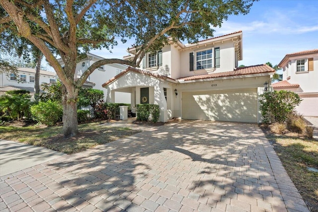 mediterranean / spanish-style home with a garage