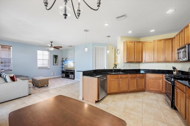 kitchen with ceiling fan with notable chandelier, sink, hanging light fixtures, appliances with stainless steel finishes, and light tile patterned flooring